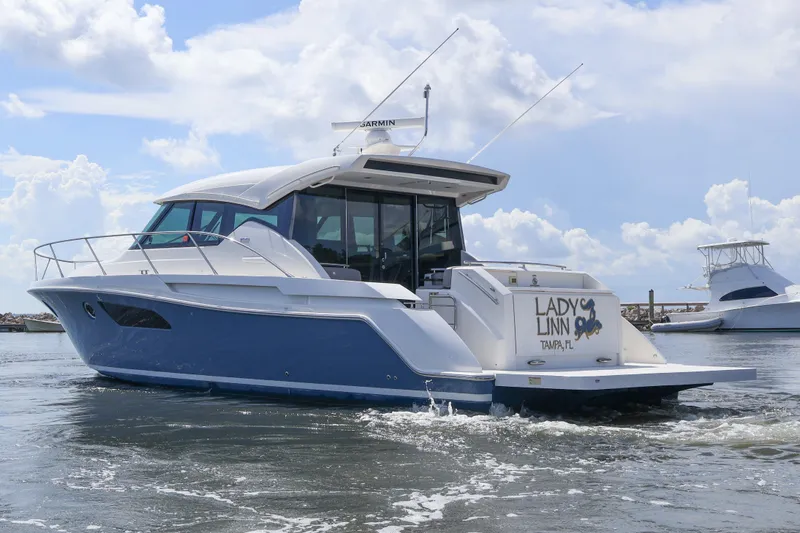 Lady Linn Yacht Photos Pics 2020 Tiara Yachts C44 Coupe cruising on water under a partly cloudy sky.
