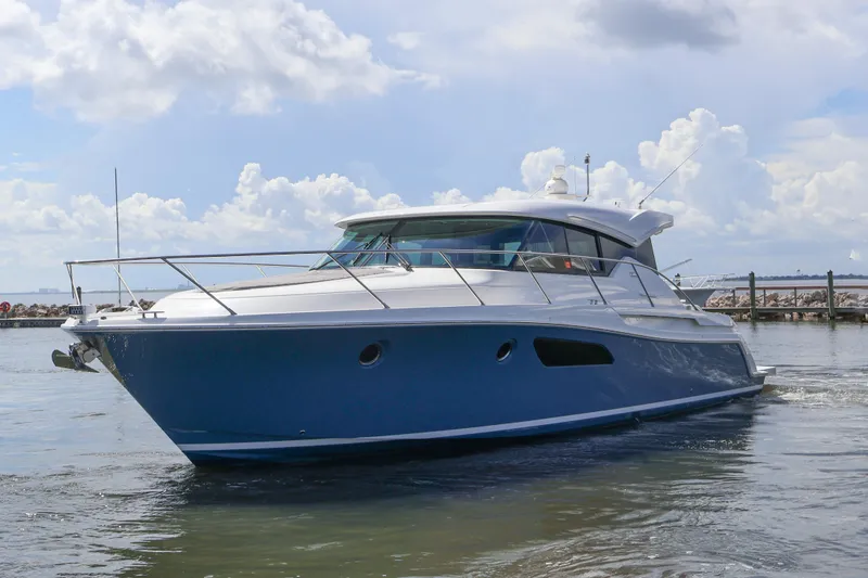 Lady Linn Yacht Photos Pics 2020 Tiara Yachts C44 Coupe cruising on calm waters under a cloudy sky.