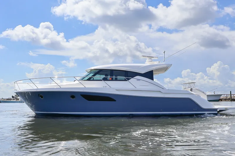 Lady Linn Yacht Photos Pics 2020 Tiara Yachts C44 Coupe cruising on a sunny day with blue skies.