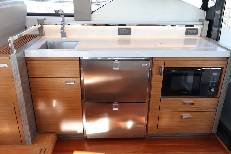 Lady Linn Yacht Photos Pics Modern kitchen area in 2020 Tiara Yachts C44 Coupe with stainless steel appliances.