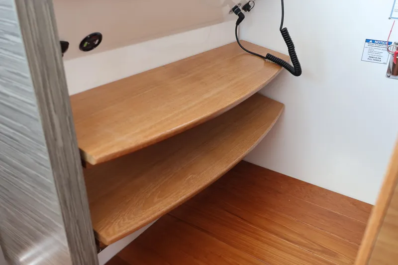 Lady Linn Yacht Photos Pics Wooden interior shelves in a 2020 Tiara Yachts C44 Coupe.