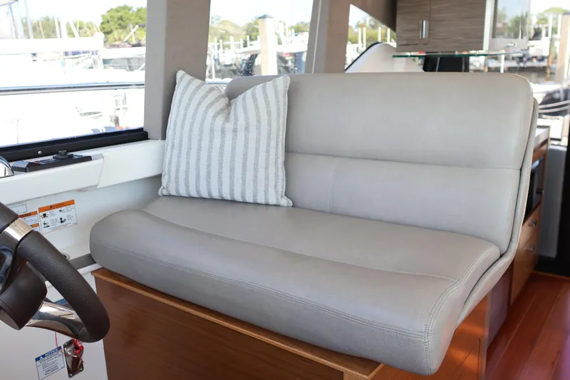 Lady Linn Yacht Photos Pics 2020 Tiara Yachts C44 Coupe interior with gray leather seating and striped pillow.