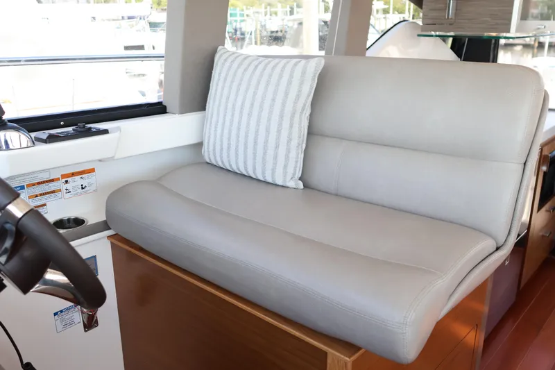 Lady Linn Yacht Photos Pics Luxurious seating area inside 2020 Tiara Yachts C44 Coupe with striped cushion.