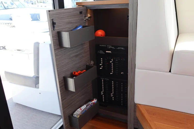 Lady Linn Yacht Photos Pics 2020 Tiara Yachts C44 Coupe electrical panel with storage compartments and modern design.