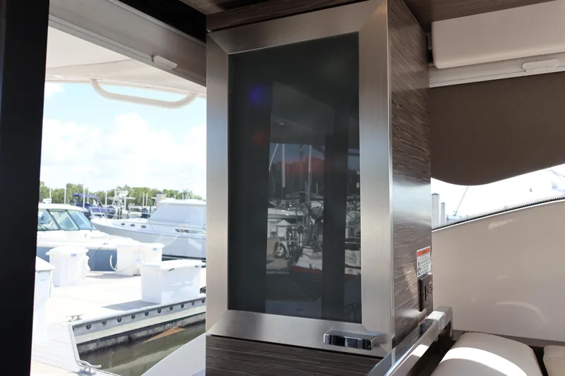 Lady Linn Yacht Photos Pics Interior view of 2020 Tiara Yachts C44 Coupe, showcasing sleek design and marina backdrop.