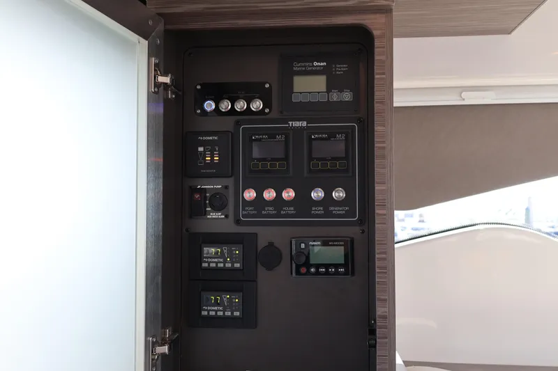 Lady Linn Yacht Photos Pics Control panel inside 2020 Tiara Yachts C44 Coupe, featuring various switches and displays.