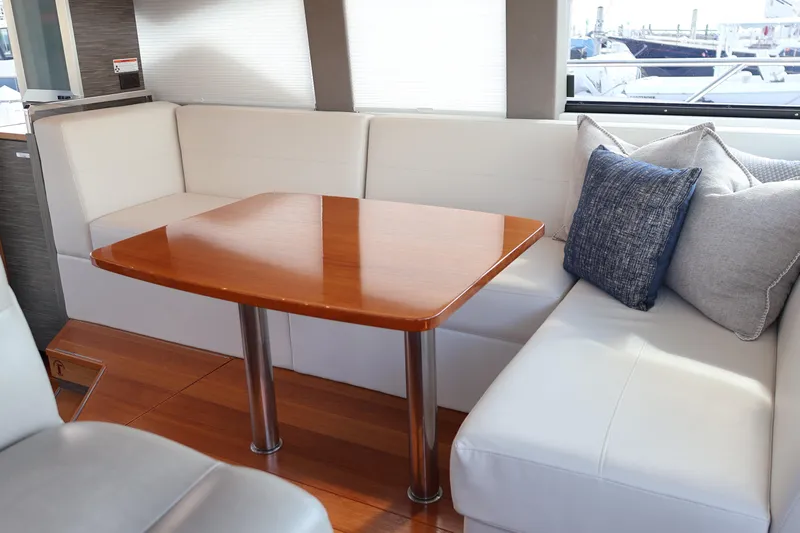 Lady Linn Yacht Photos Pics 2020 Tiara Yachts C44 Coupe interior with elegant seating and wooden table.