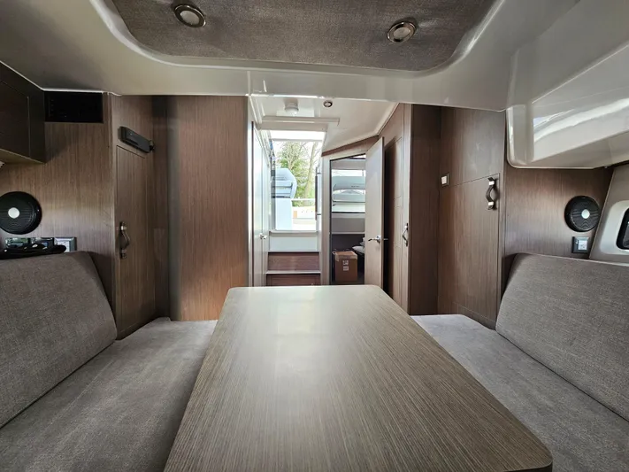  Yacht Photos Pics 2024 Beneteau Flyer 10 interior with modern wood finish and comfortable seating.