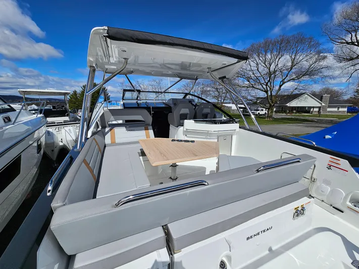  Yacht Photos Pics 2024 Beneteau Flyer 10 boat with spacious seating and table, under a clear blue sky.