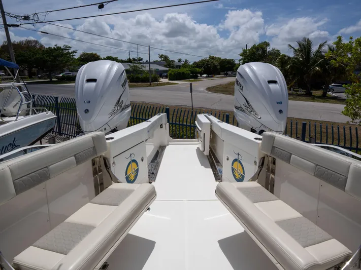  Yacht Photos Pics 2020 Solace 34 boat with twin outboard engines, spacious seating, and clear skies.