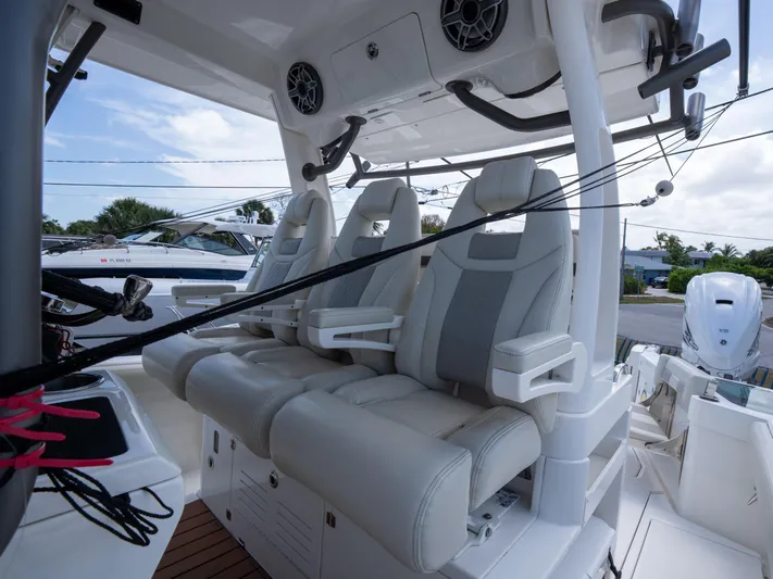  Yacht Photos Pics 2020 Solace 34 boat interior with three cushioned seats and modern design.