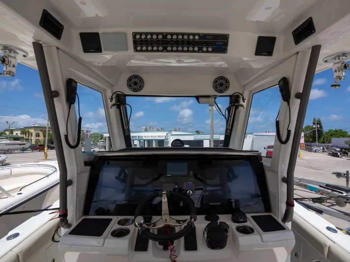 Yacht Photos Pics Interior view of 2020 Solace 34 boat cockpit with steering wheel and controls.