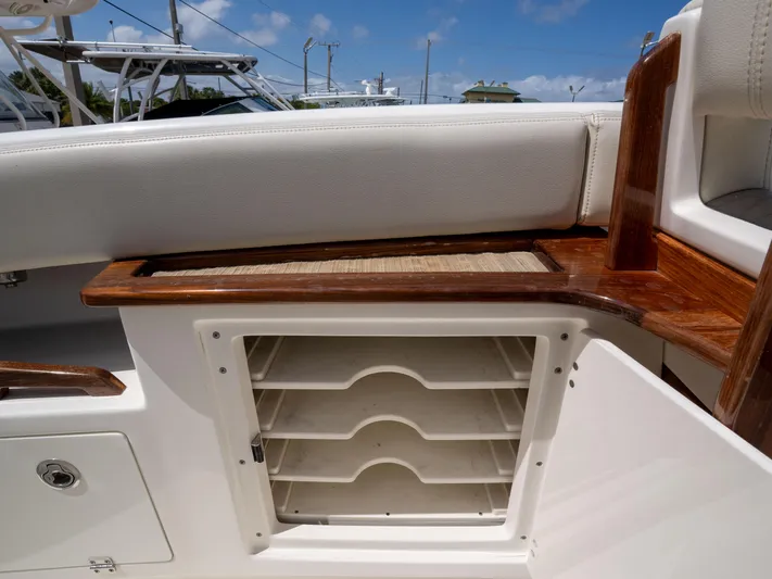  Yacht Photos Pics Interior view of a 2020 Solace 34 boat, featuring storage compartments and wooden accents.