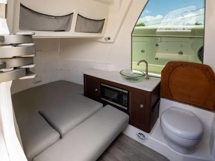  Yacht Photos Pics Interior of 2020 Solace 34 boat with bed, kitchenette, and toilet.