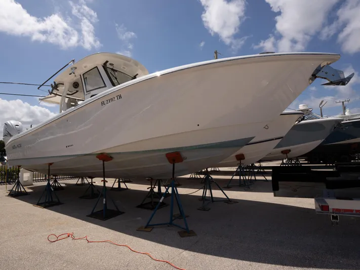  Yacht Photos Pics 2020 Solace 34 boat on stands under a partly cloudy sky.