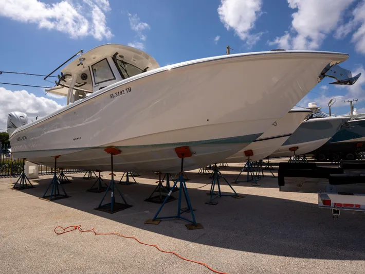  Yacht Photos Pics 2020 Solace 34 boat on stands under a clear blue sky.