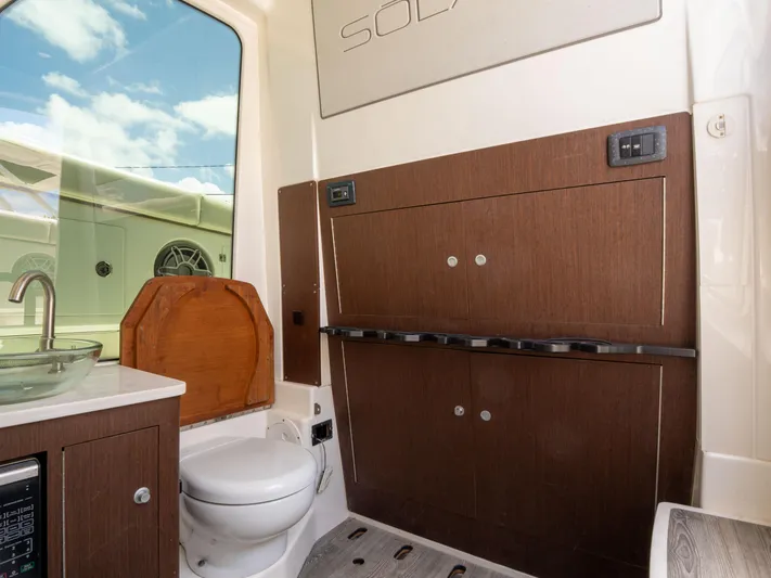  Yacht Photos Pics 2020 Solace 34 boat interior bathroom with modern fixtures and wooden cabinetry.