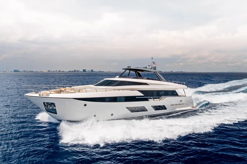 Our Trade Yacht Photos Pics Luxurious 2021 Ferretti Yachts 920 cruising on open sea under cloudy sky.