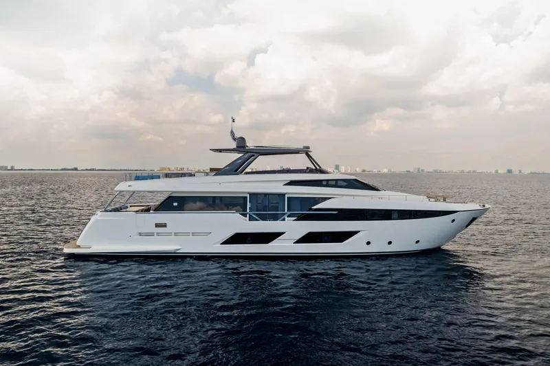 Our Trade Yacht Photos Pics 2021 Ferretti Yachts 920 luxury yacht cruising on open water under cloudy skies.