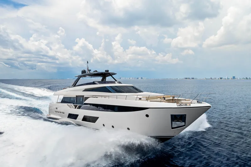 Our Trade Yacht Photos Pics Luxurious 2021 Ferretti Yachts 920 cruising on open sea under cloudy sky.