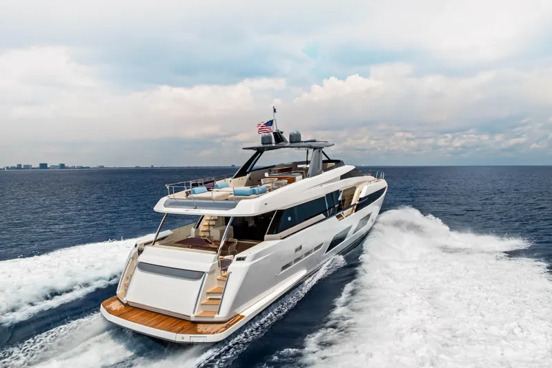 Our Trade Yacht Photos Pics Luxurious 2021 Ferretti Yachts 920 cruising on open sea under a cloudy sky.