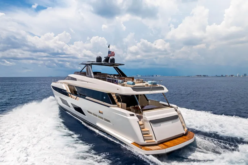 Our Trade Yacht Photos Pics Luxurious 2021 Ferretti Yachts 920 cruising on open sea under cloudy sky.