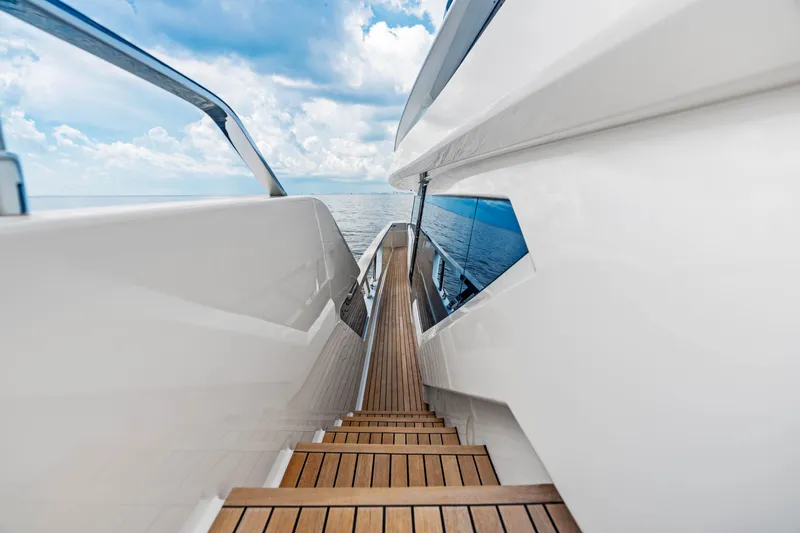 Our Trade Yacht Photos Pics Ferretti Yachts 920 (2021) deck view with ocean backdrop and wooden steps.