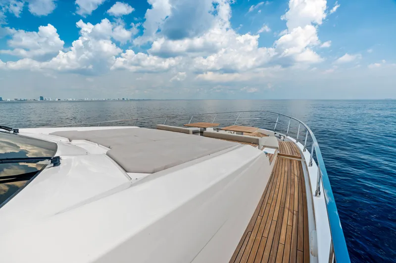 Our Trade Yacht Photos Pics Luxurious 2021 Ferretti Yachts 920 cruising on open sea under a partly cloudy sky.