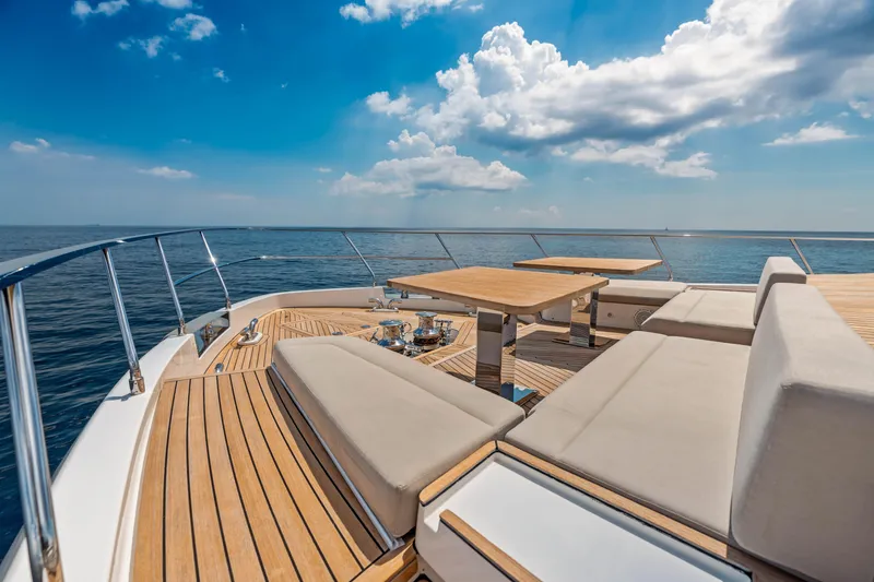 Our Trade Yacht Photos Pics Luxurious 2021 Ferretti Yachts 920 deck with seating, ocean view, and blue sky.