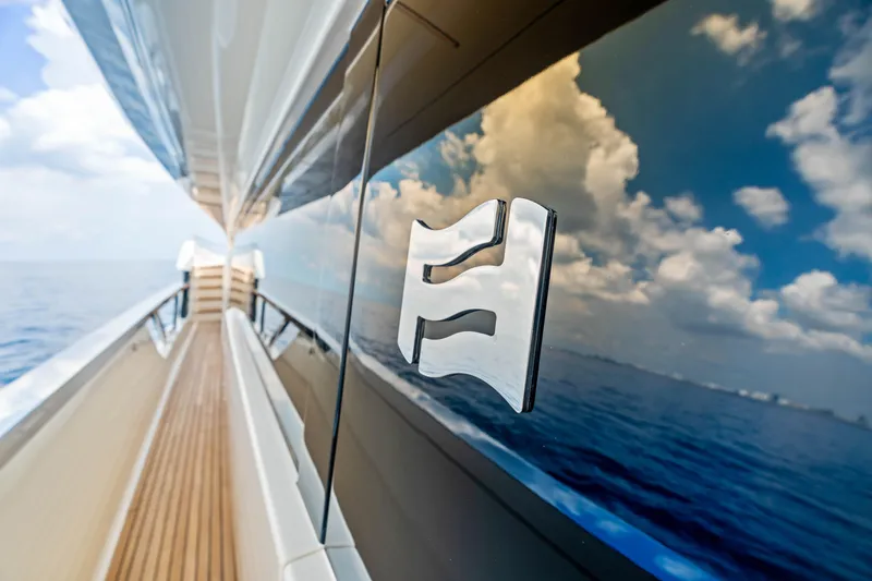 Our Trade Yacht Photos Pics Sleek Ferretti Yachts 920, 2021 model, reflecting ocean and sky on glossy exterior.