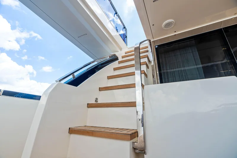 Our Trade Yacht Photos Pics Staircase on 2021 Ferretti Yachts 920, leading to upper deck under blue sky.
