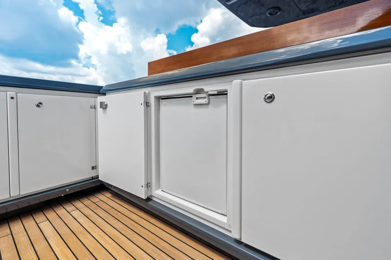Our Trade Yacht Photos Pics Luxury Ferretti Yachts 920 deck cabinetry, 2021 model, with sleek white finish and wooden flooring.