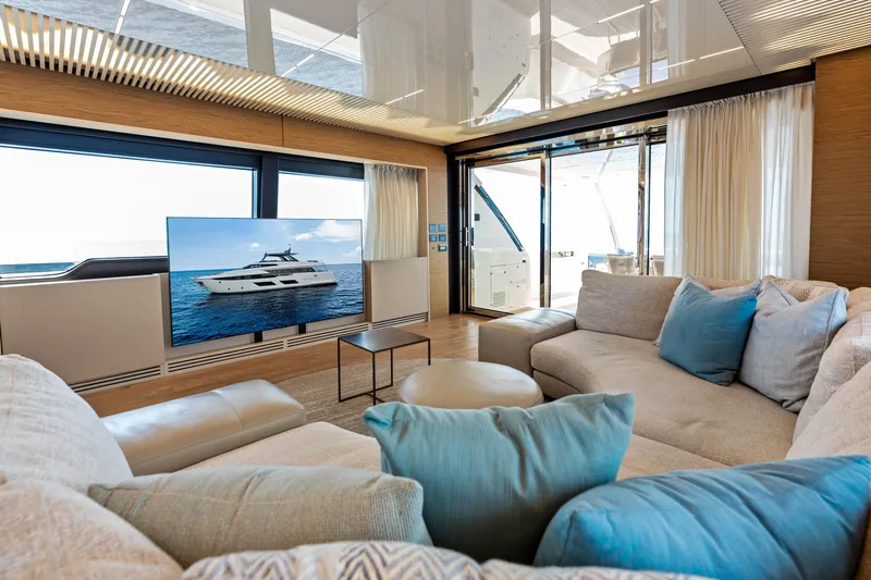 Our Trade Yacht Photos Pics Luxurious interior of 2021 Ferretti Yachts 920 with plush seating and large TV.