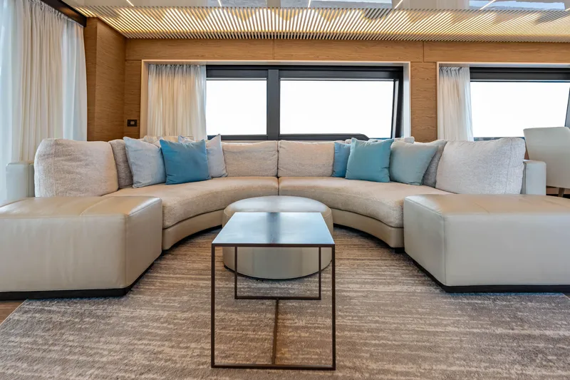 Our Trade Yacht Photos Pics Luxurious interior of 2021 Ferretti Yachts 920 with elegant curved sofa and modern decor.