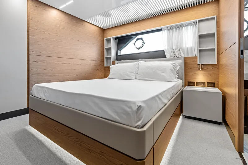 Our Trade Yacht Photos Pics Luxurious bedroom interior of 2021 Ferretti Yachts 920 with modern design and wood accents.