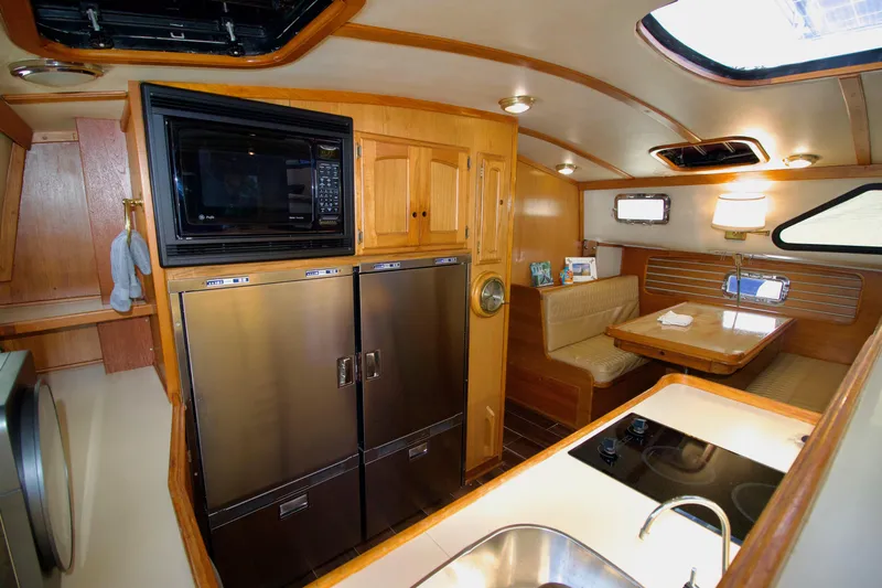 Sarita Sea Yacht Photos Pics Interior of 1983 Lancer Yachts Motorsailer with kitchen and dining area.