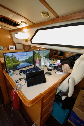 Sarita Sea Yacht Photos Pics Interior of 1983 Lancer Yachts Motorsailer with desk, dual monitors, and office setup.