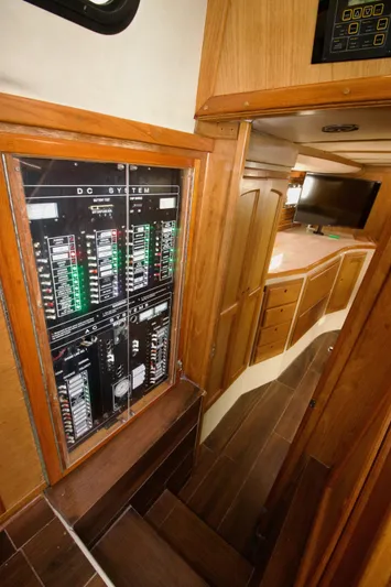 Sarita Sea Yacht Photos Pics 1983 Lancer Yachts Motorsailer interior with control panel and wooden cabinetry.