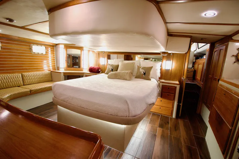 Sarita Sea Yacht Photos Pics Luxurious 1983 Lancer Yachts Motorsailer interior with elegant wood finishes and cozy bedding.