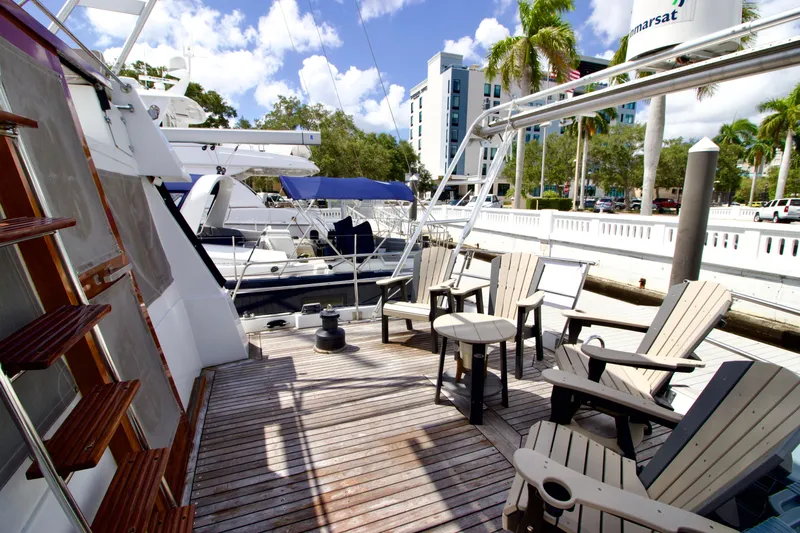 Sarita Sea Yacht Photos Pics 1983 Lancer Yachts Motorsailer deck with seating, docked at marina under blue sky.