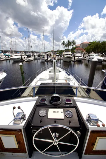 Sarita Sea Yacht Photos Pics 1983 Lancer Yachts Motorsailer at marina, view from helm, sunny day, sailboats in background.