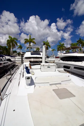 Sarita Sea Yacht Photos Pics 1983 Lancer Yachts Motorsailer docked under a vibrant blue sky with palm trees.