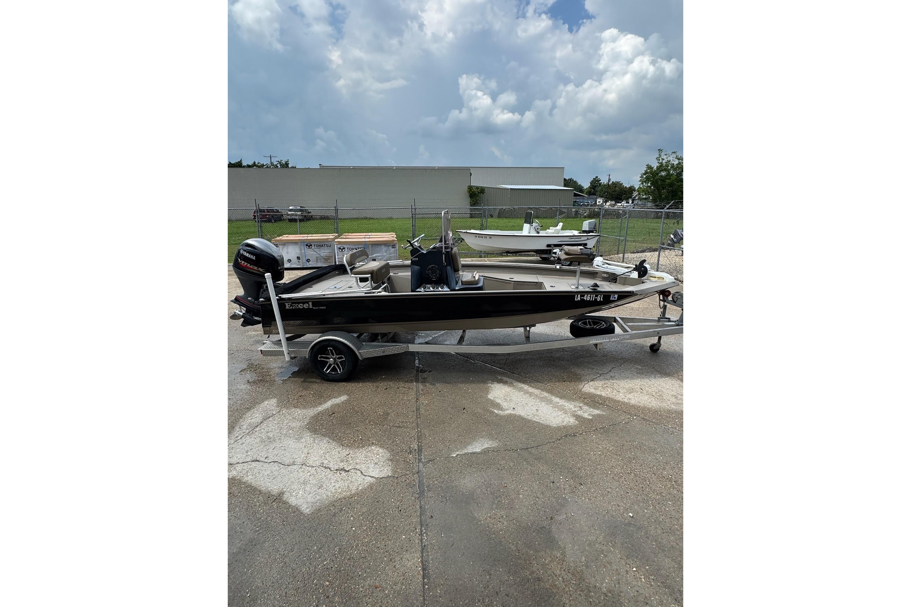 2020 Excel 203 Bay Pro boat on trailer, parked outdoors under cloudy sky.