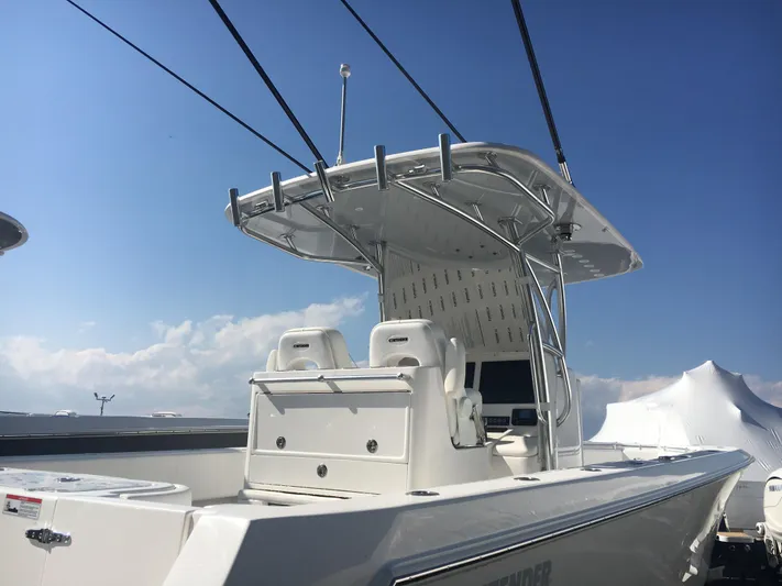  Yacht Photos Pics 2024 Contender 32 ST boat with dual seats and T-top under a clear sky.