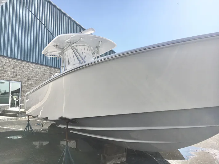  Yacht Photos Pics 2024 Contender 32 ST boat on stands outside a warehouse.