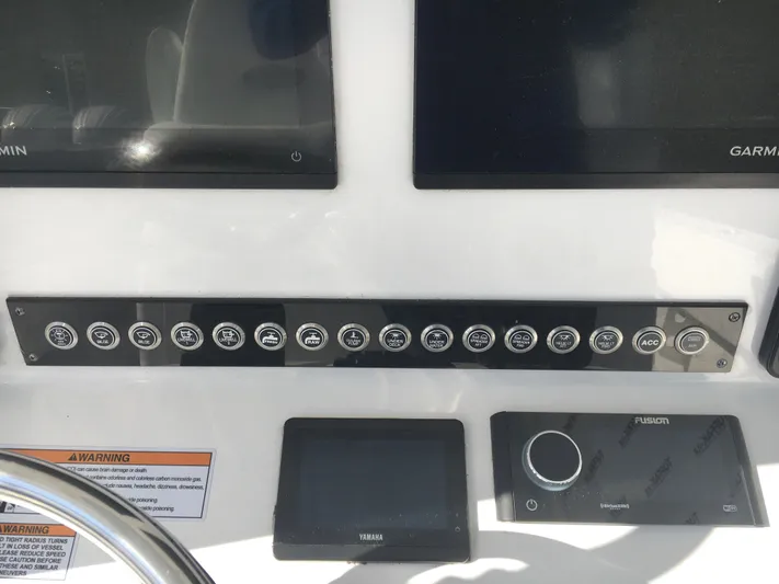  Yacht Photos Pics Control panel of 2024 Contender 32 ST boat with Garmin and Fusion displays.