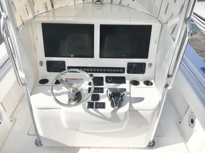  Yacht Photos Pics 2024 Contender 32 ST boat console with dual screens and steering wheel.