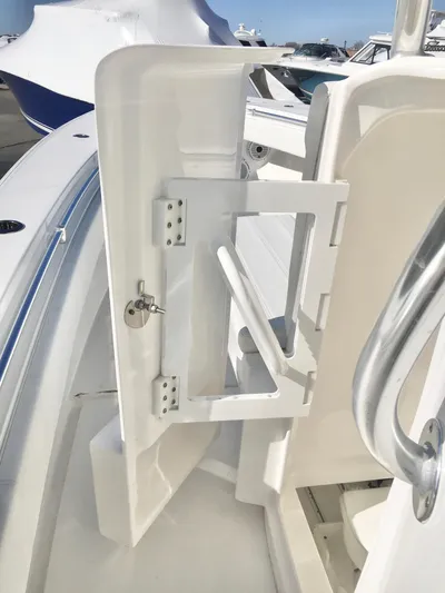  Yacht Photos Pics 2024 Contender 32 ST boat interior with open storage compartment and sleek design.