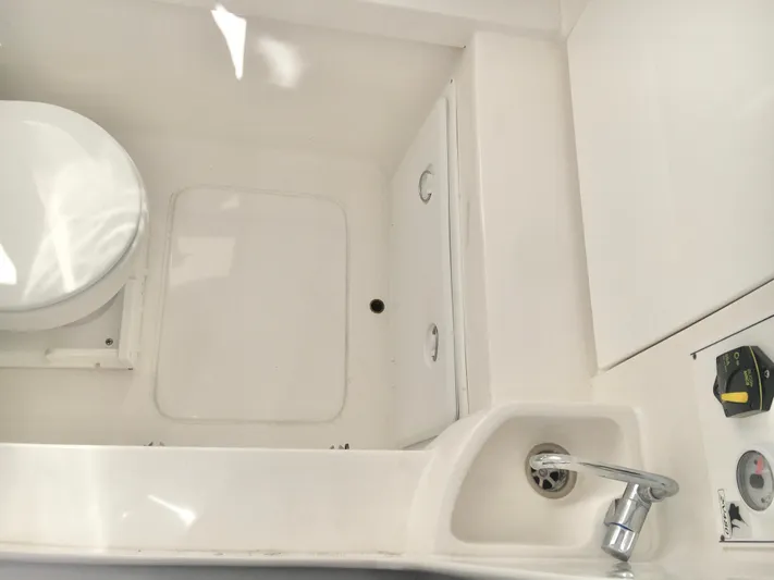  Yacht Photos Pics 2024 Contender 32 ST boat interior with toilet and sink.