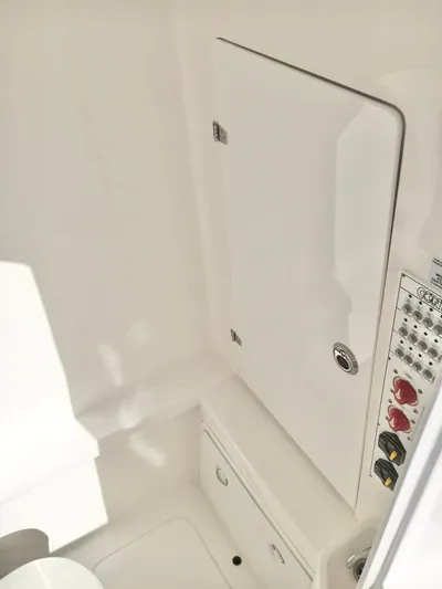  Yacht Photos Pics 2024 Contender 32 ST interior with control panel and storage compartment.